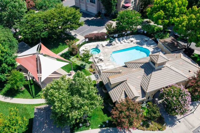 an aerial view of a house with a yard