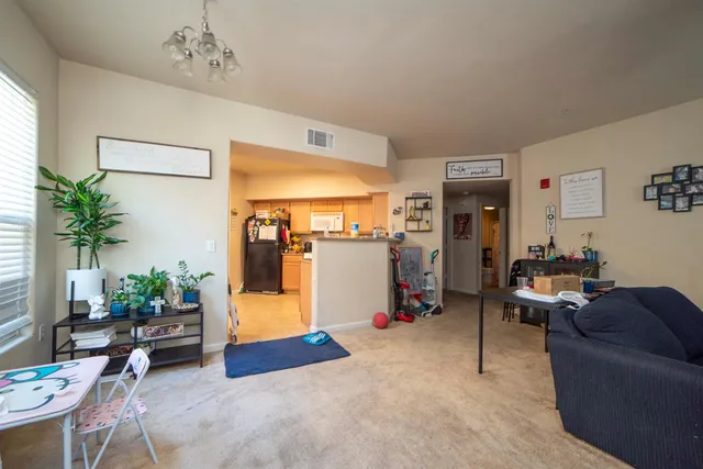a living room with furniture and a chandelier