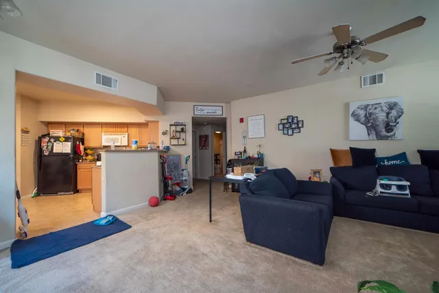 a living room with furniture and kitchen view