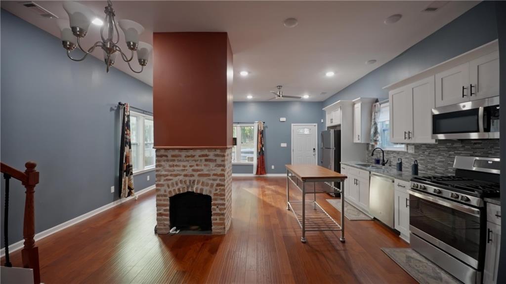 884 Coleman Street Southwest Atlanta, GA 30310 - Photo 12 of 30 a large kitchen with stainless steel appliances granite countertop a stove and a wooden floors