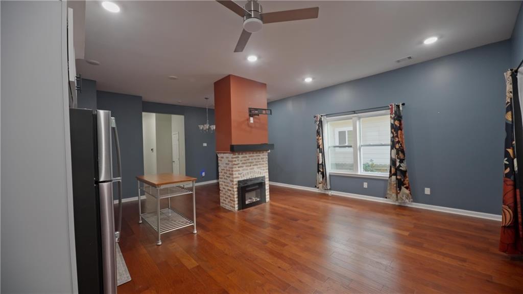 884 Coleman Street Southwest Atlanta, GA 30310 - Photo 14 of 30 an empty room with wooden floor and windows