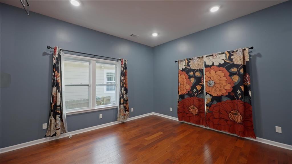 884 Coleman Street Southwest Atlanta, GA 30310 - Photo 15 of 30 an empty room with wooden floor and window