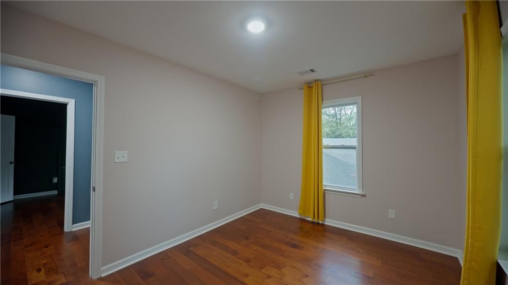 884 Coleman Street Southwest Atlanta, GA 30310 - Photo 26 of 30 an empty room with wooden floor and windows