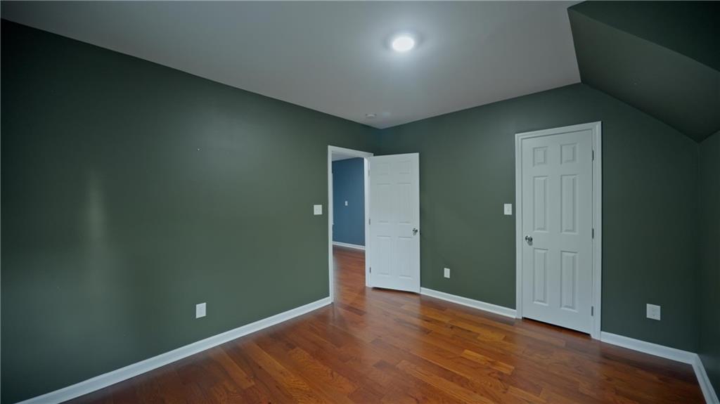 884 Coleman Street Southwest Atlanta, GA 30310 - Photo 30 of 30 an empty room with wooden floor and closet