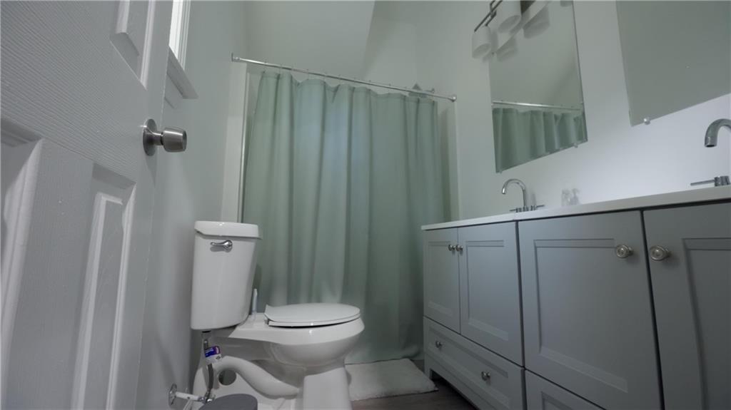 884 Coleman Street Southwest Atlanta, GA 30310 - Photo 6 of 30 a white toilet sitting next to a shower