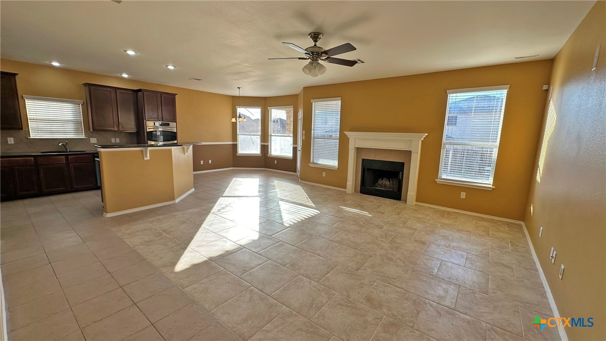 5203 Willamette Lane Killeen, TX 76549 - Photo 11 of 48 a view of an empty room with a fireplace and a window
