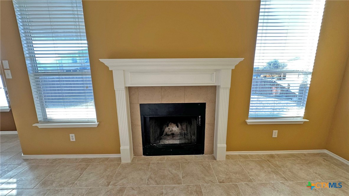 5203 Willamette Lane Killeen, TX 76549 - Photo 13 of 48 a view of an empty room with a fireplace and a window
