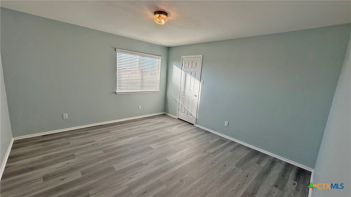 5203 Willamette Lane Killeen, TX 76549 - Photo 33 of 48 an empty room with wooden floor and windows