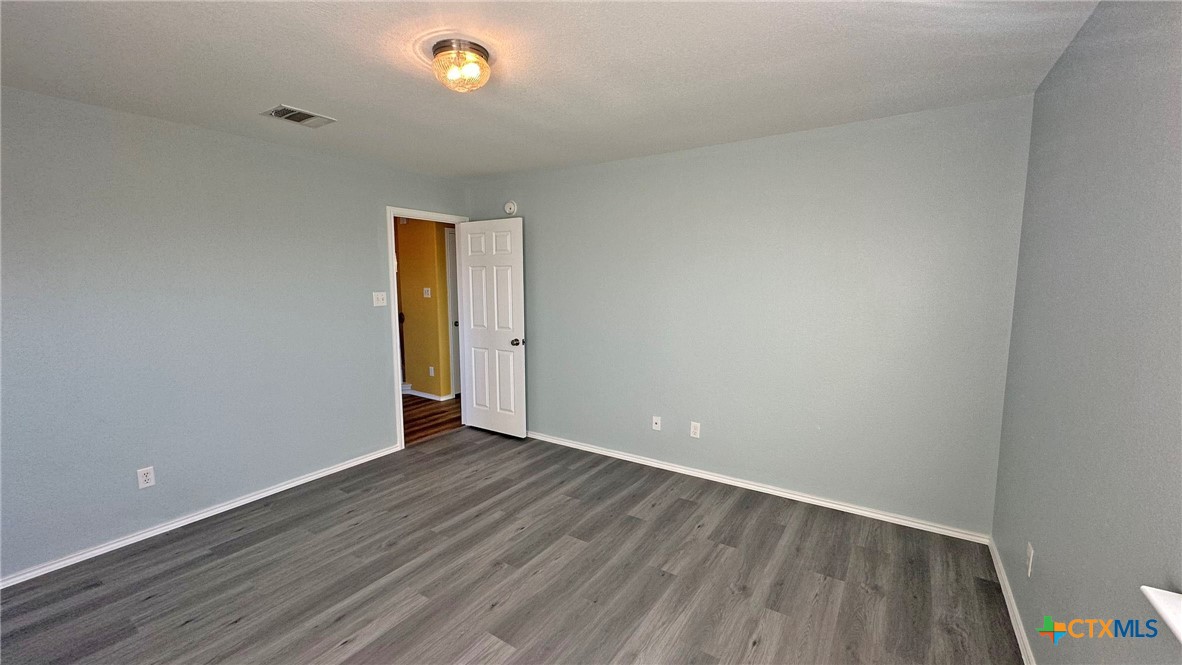 5203 Willamette Lane Killeen, TX 76549 - Photo 34 of 48 a view of an empty room with wooden floor and a window