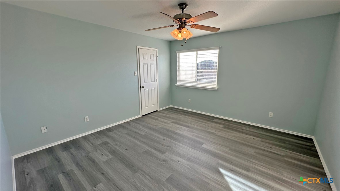 5203 Willamette Lane Killeen, TX 76549 - Photo 36 of 48 wooden floor in an empty room with a window