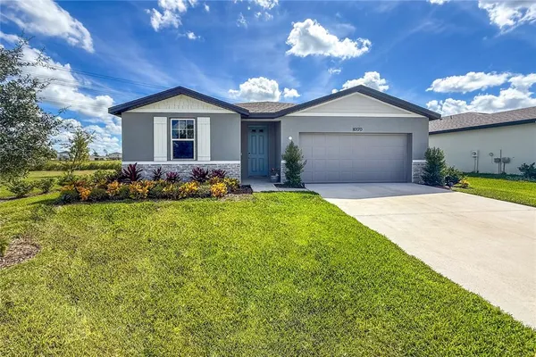 a front view of a house with a yard and garage