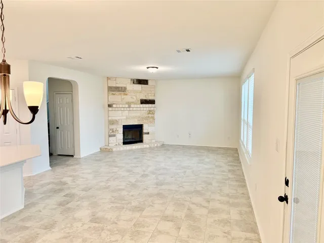 a view of a kitchen with kitchen island a sink stainless steel appliances and cabinets