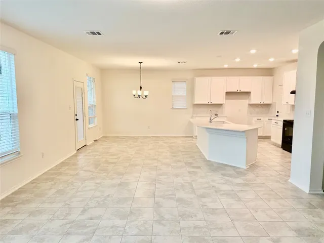 a view of a kitchen with a sink and a fireplace