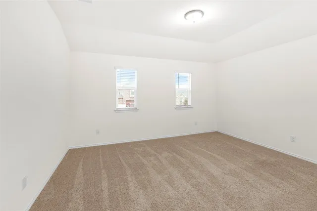 an empty room with windows and pillars in it