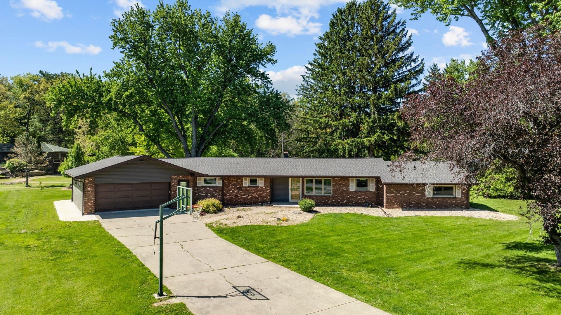 313 West Margaret Fuller Road Oregon, IL 61061 - Photo 2 of 46 a view of a house with a patio and a yard