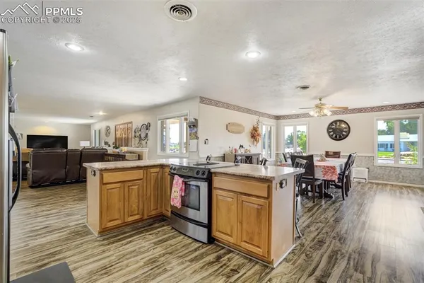 a kitchen with stainless steel appliances granite countertop a stove and cabinets