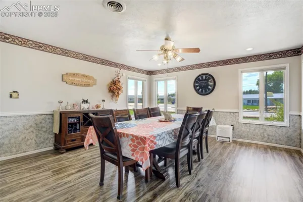 a view of a dining room and livingroom with furniture window and wooden floor