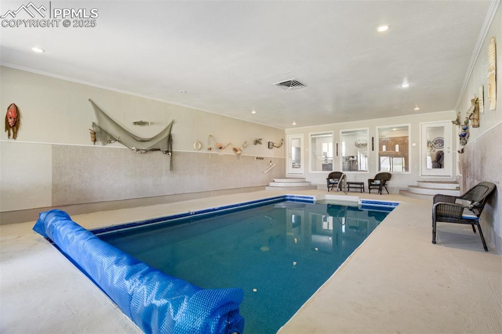 27875 County Farm Road Pueblo, CO 81006 - Photo 28 of 50 a living room with kitchen island a stove a sink dishwasher and a dining table with the view of kitchen