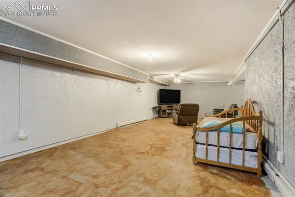 a bedroom with furniture and a flat screen tv