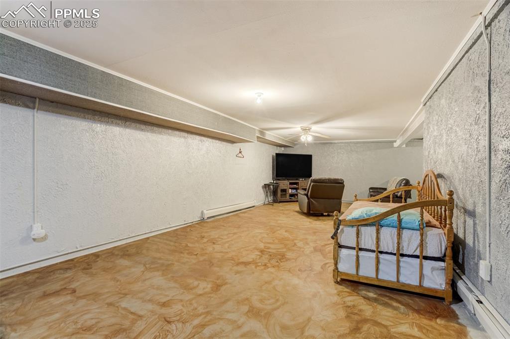 27875 County Farm Road Pueblo, CO 81006 - Photo 30 of 50 a bedroom with furniture and a flat screen tv