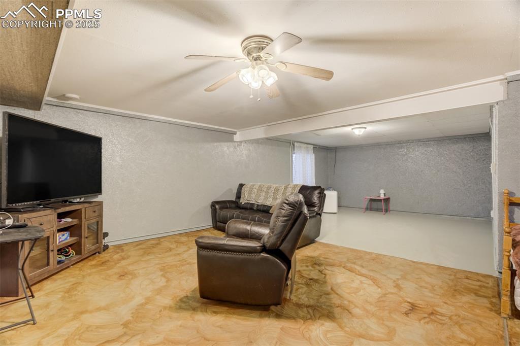 27875 County Farm Road Pueblo, CO 81006 - Photo 31 of 50 a living room with furniture and a flat screen tv
