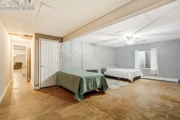 a spacious bedroom with a bed and a window