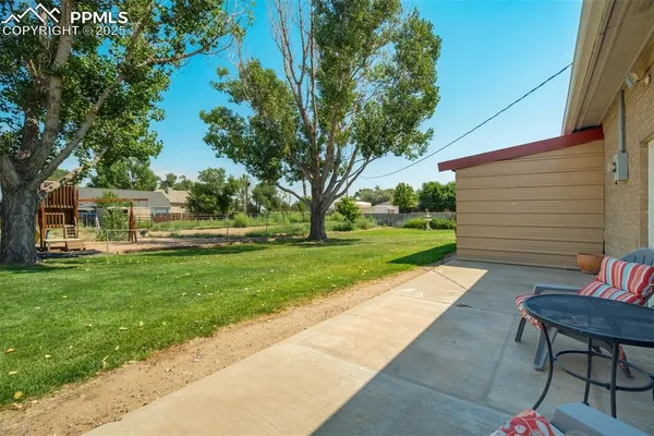 a view of backyard with sitting area
