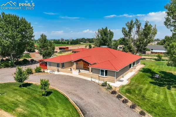 an aerial view of a house with yard patio and outdoor seating