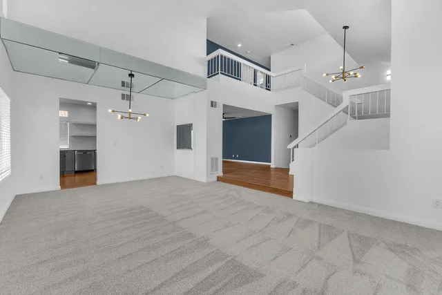 a view of a hallway with a chandelier and a chandelier