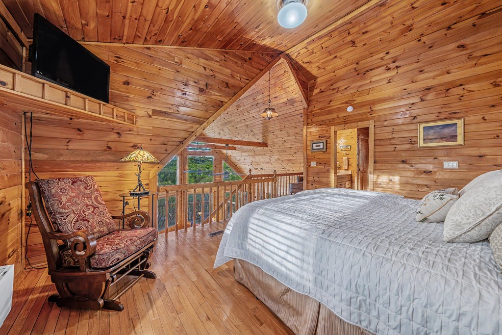 431 Sun Rock Mountain Road Blue Ridge, GA 30513 - Photo 30 of 57 a bedroom with a bed and wooden floor