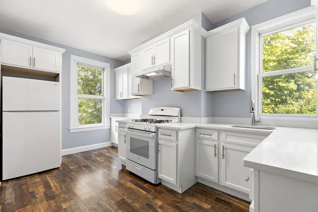 a kitchen with a stove a sink and a refrigerator
