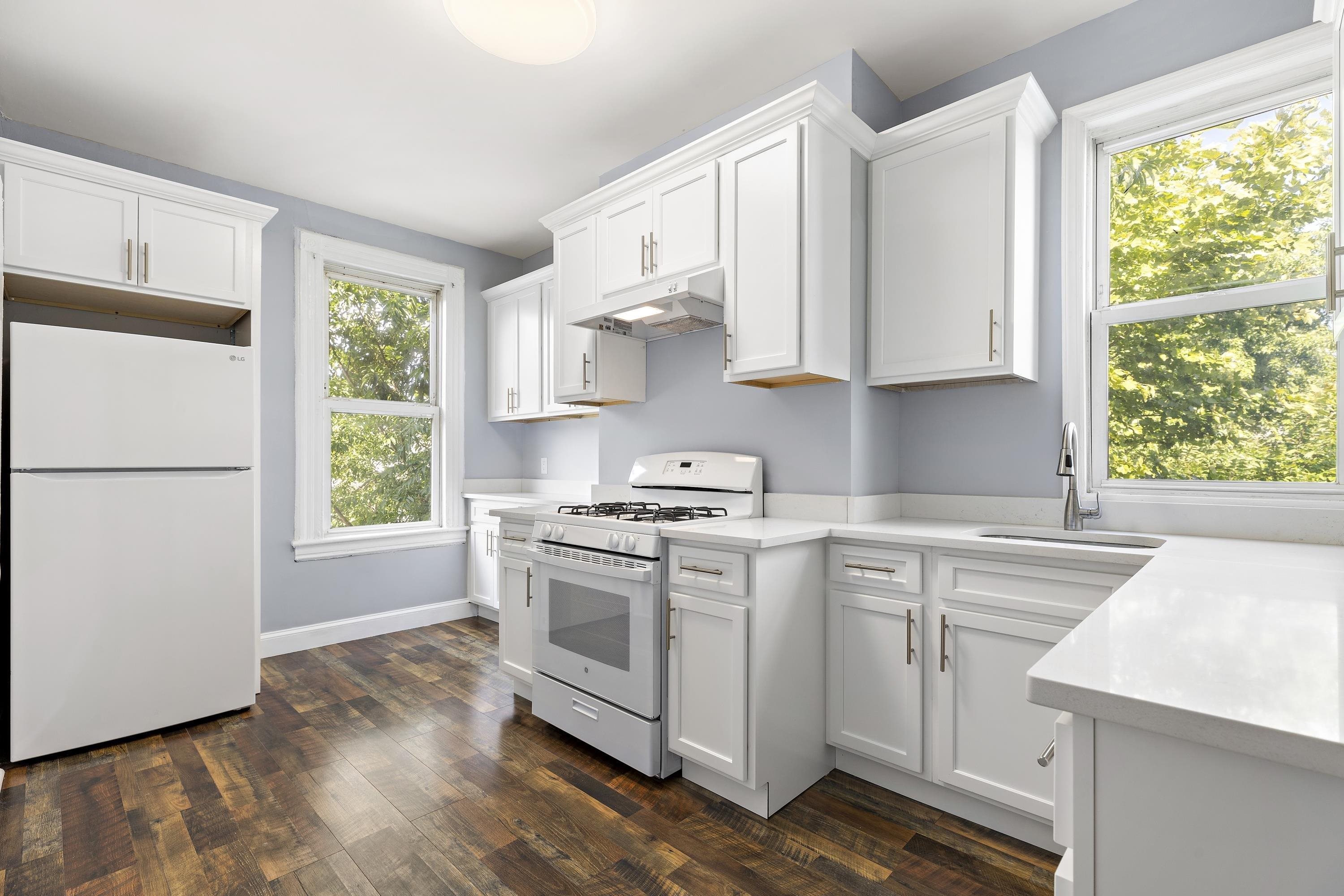 11 Hudson Place, Unit 2 Weehawken, NJ 07086 - Photo 2 of 16 a kitchen with a stove a sink and a refrigerator