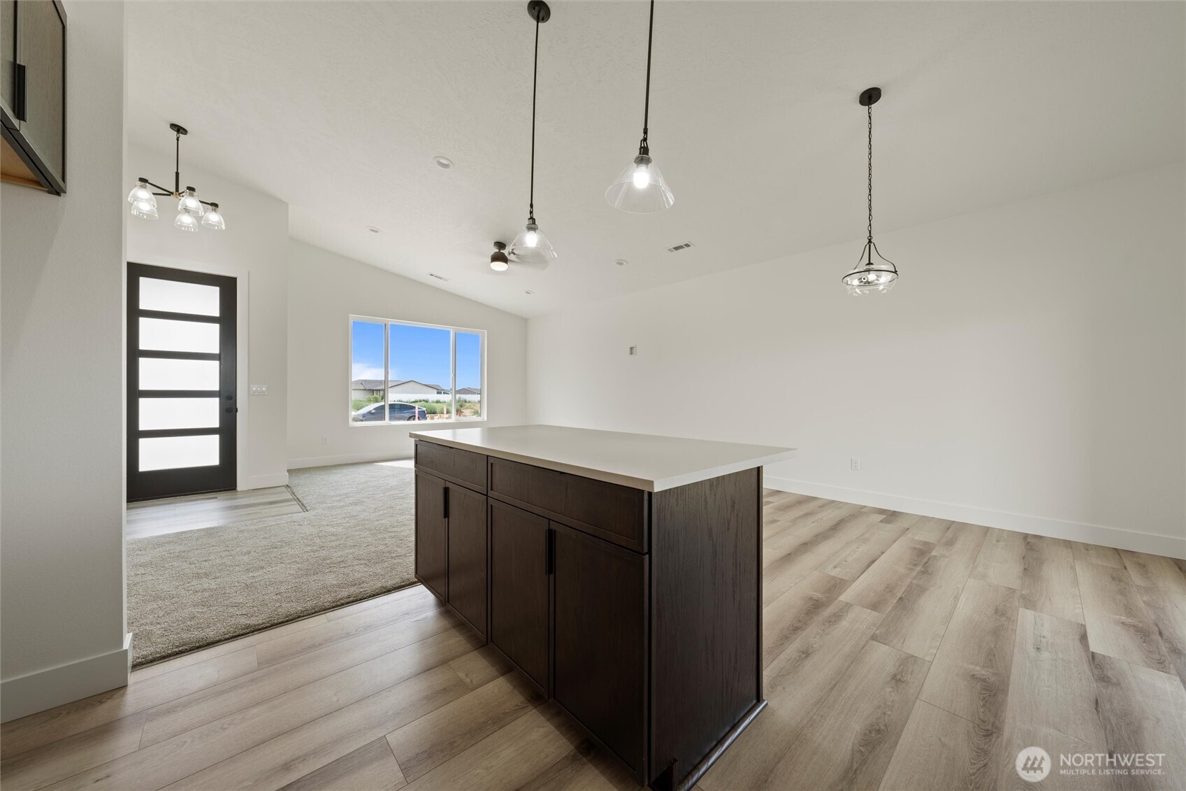 701 O Street Southwest Quincy, WA 98848 - Photo 22 of 33 a kitchen with kitchen island a counter top space appliances and a ceiling fan