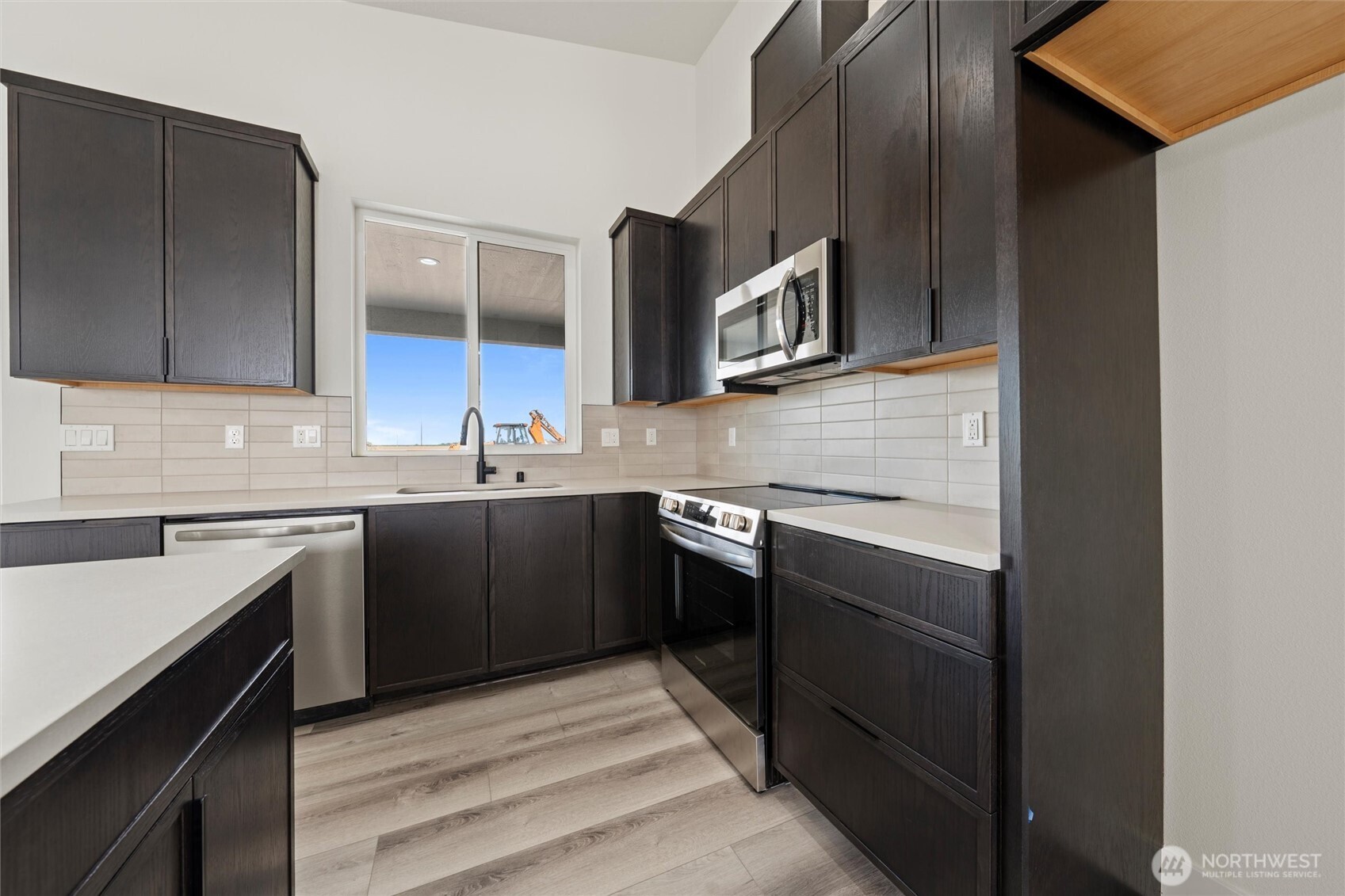 701 O Street Southwest Quincy, WA 98848 - Photo 23 of 33 a kitchen with stainless steel appliances granite countertop a sink and stove top oven