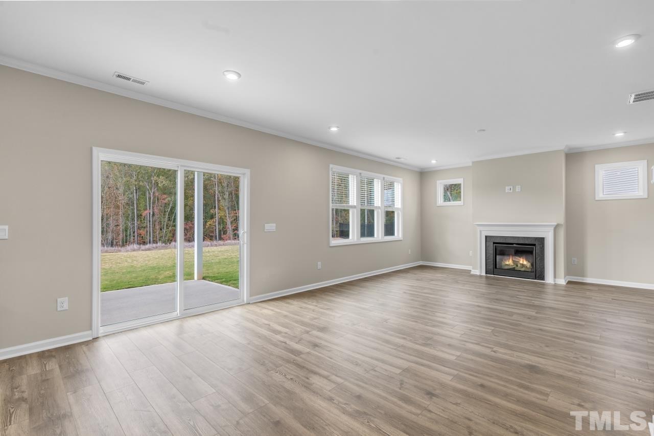 47 Madden Rose Loop Garner, NC 27529 - Photo 15 of 31 a view of empty room with wooden floor and fireplace