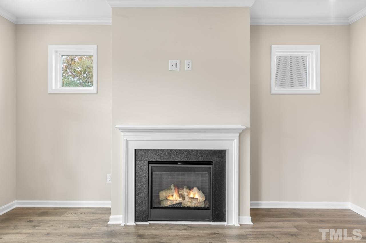 47 Madden Rose Loop Garner, NC 27529 - Photo 16 of 31 a white building with a fireplace