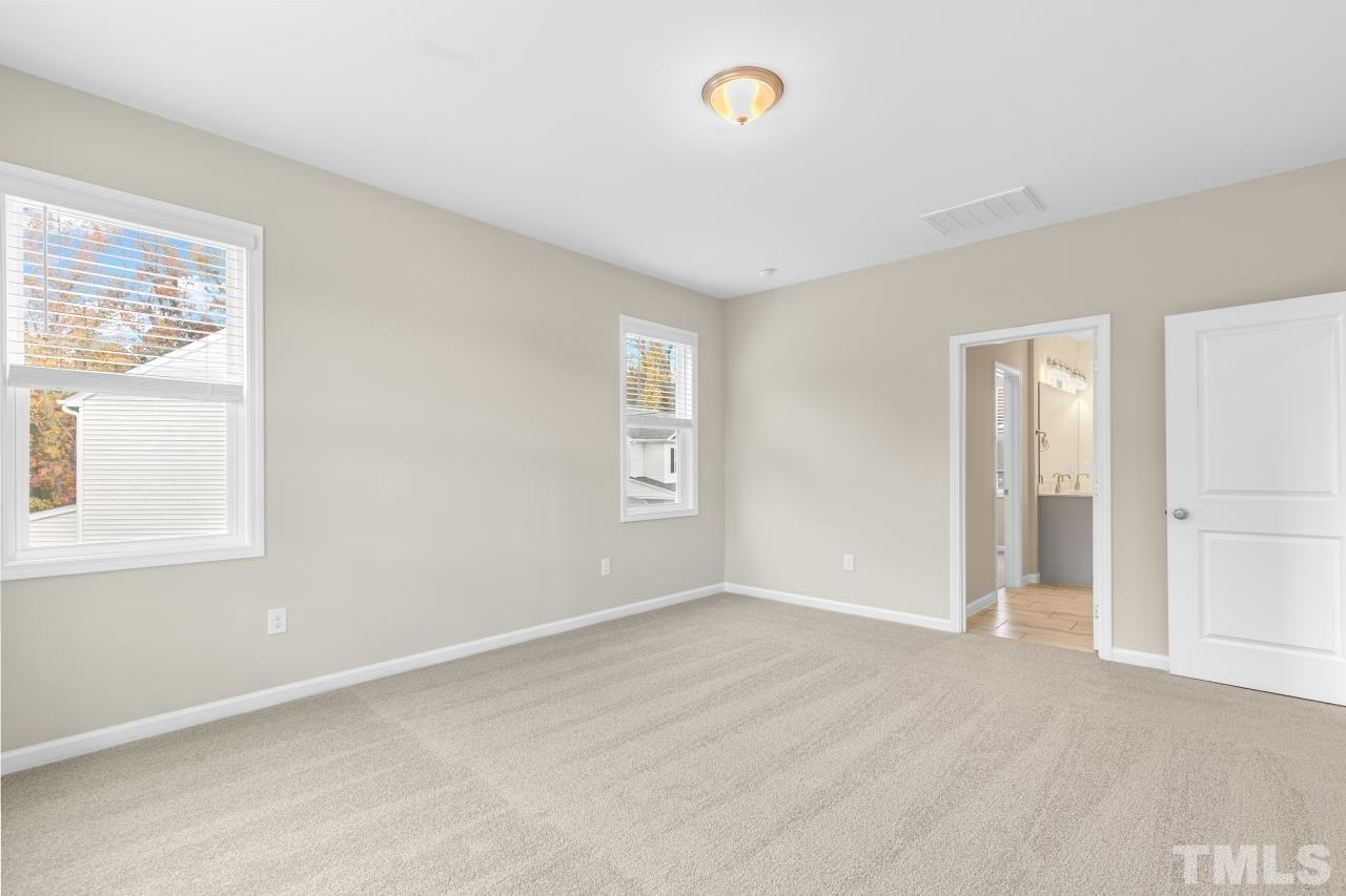 47 Madden Rose Loop Garner, NC 27529 - Photo 20 of 31 a view of an empty room with a window