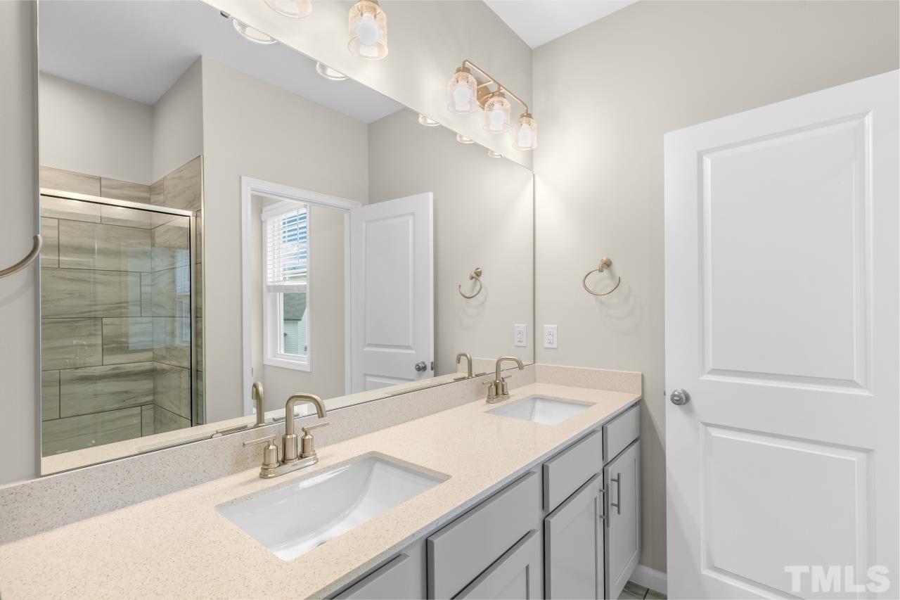 47 Madden Rose Loop Garner, NC 27529 - Photo 22 of 31 a bathroom with a sink double vanity and a mirror