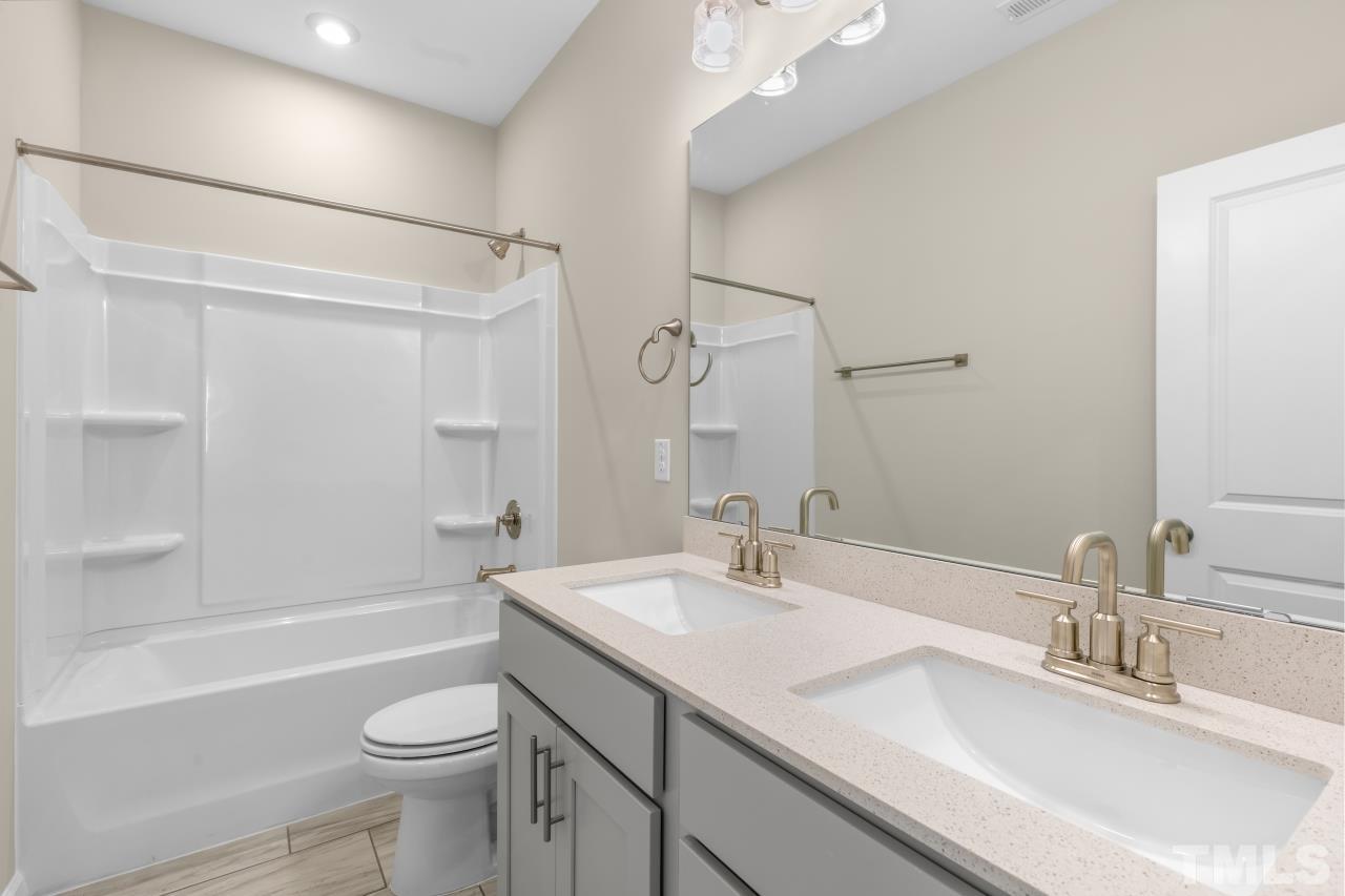 47 Madden Rose Loop Garner, NC 27529 - Photo 29 of 31 a bathroom with a sink a toilet and a bathtub