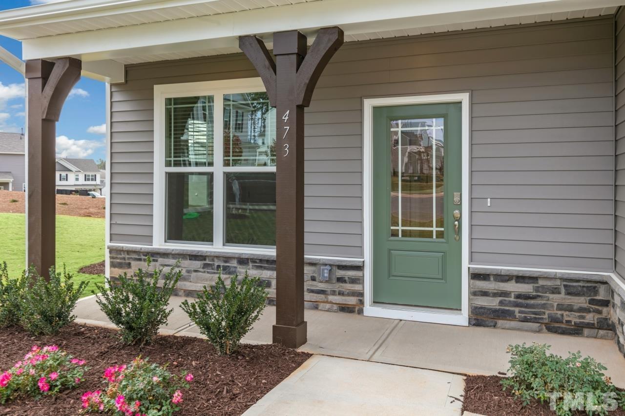 47 Madden Rose Loop Garner, NC 27529 - Photo 6 of 31 a front view of a house with potted plants