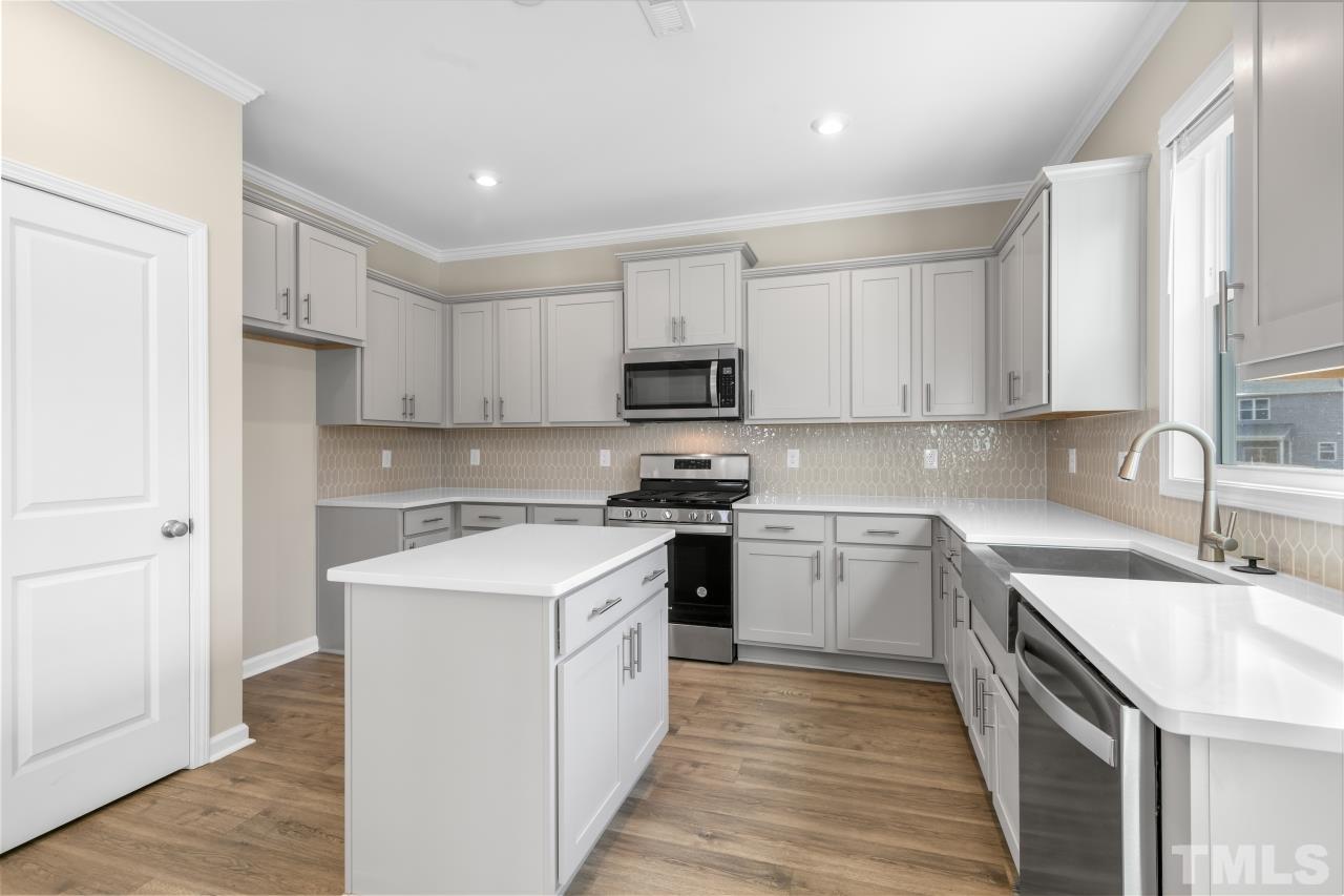 47 Madden Rose Loop Garner, NC 27529 - Photo 9 of 31 a kitchen with a sink stove top oven and refrigerator