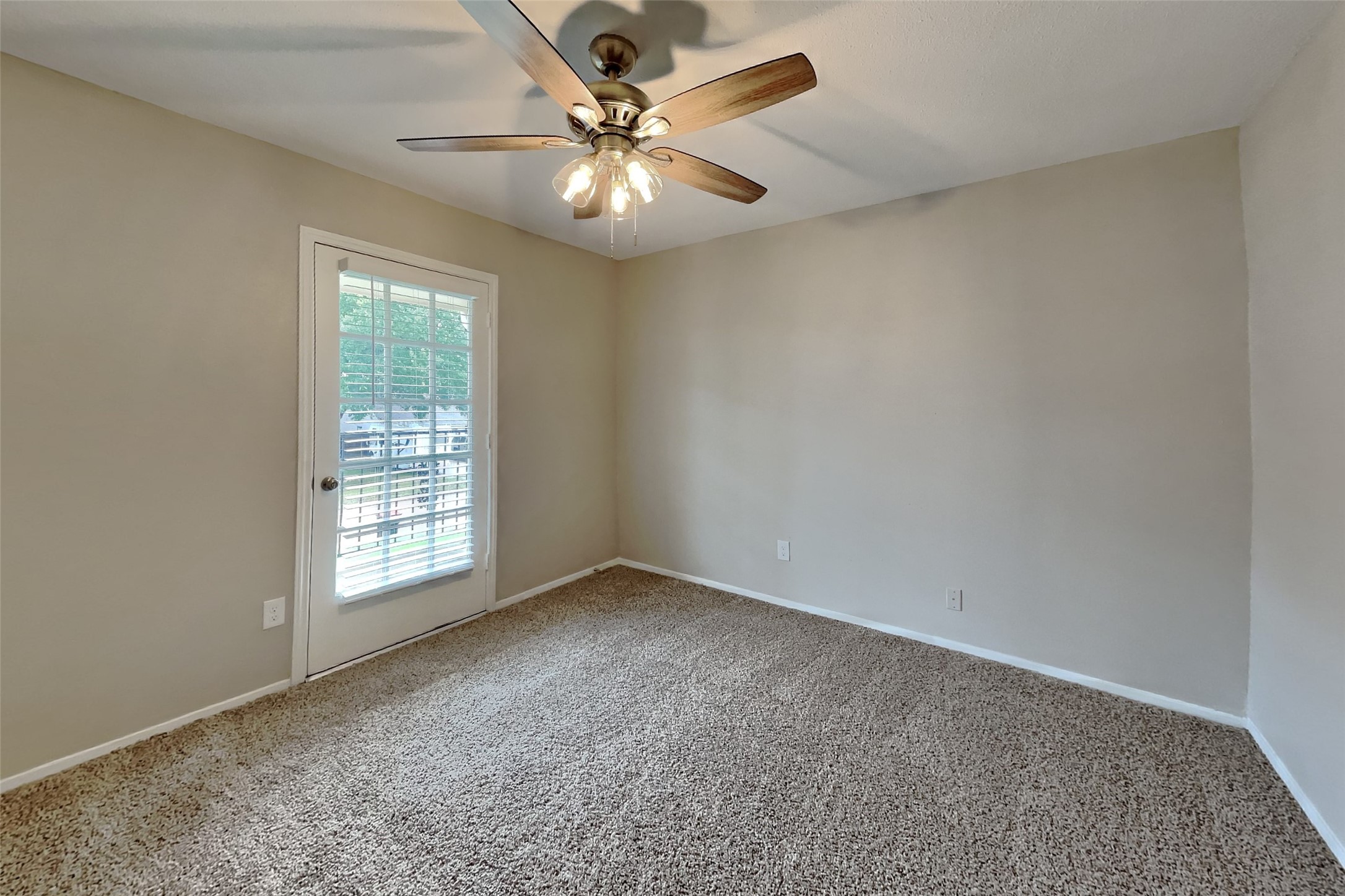 10015 Rippling Fields Drive Houston, TX 77064 - Photo 17 of 24 an empty room with windows and fan