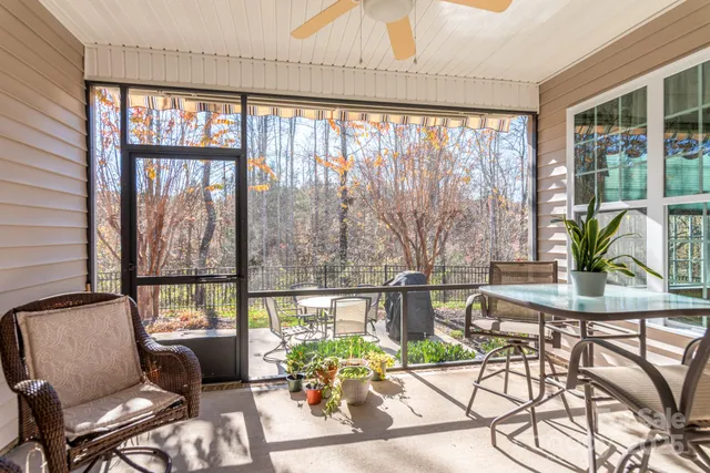 a view of a patio with couches table and chairs and potted plants