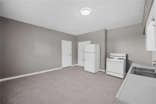 a view of a room with refrigerator and white walls