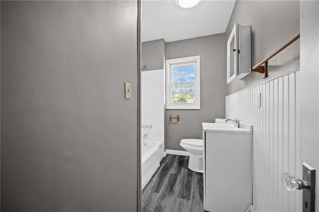 a bathroom with a toilet a sink and a window