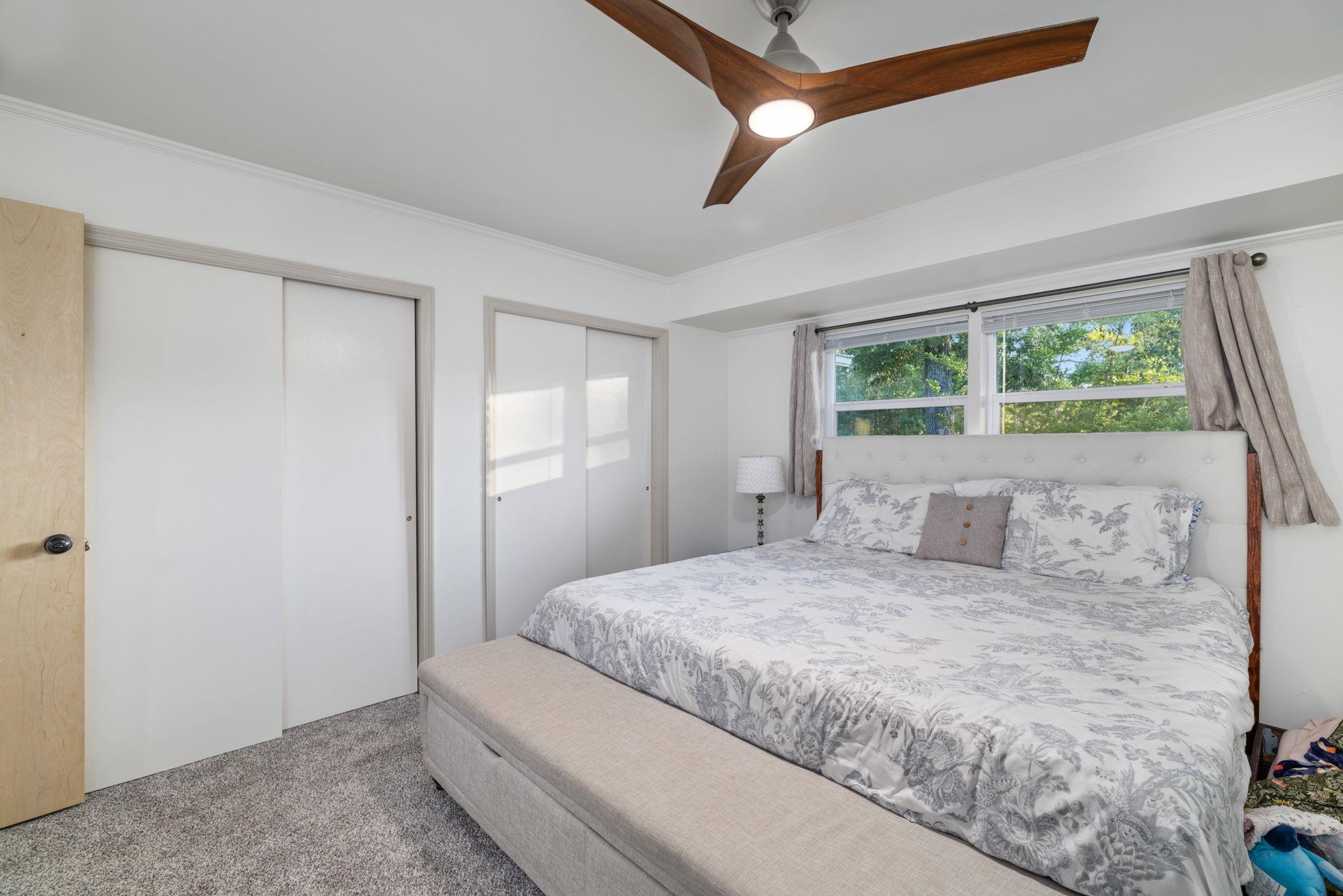 66 County Road 511 Corinth, MS 38834 - Photo 18 of 40 Bedroom featuring light gray carpet flooring, a modern ceiling fan with wood-finish blades, and white walls