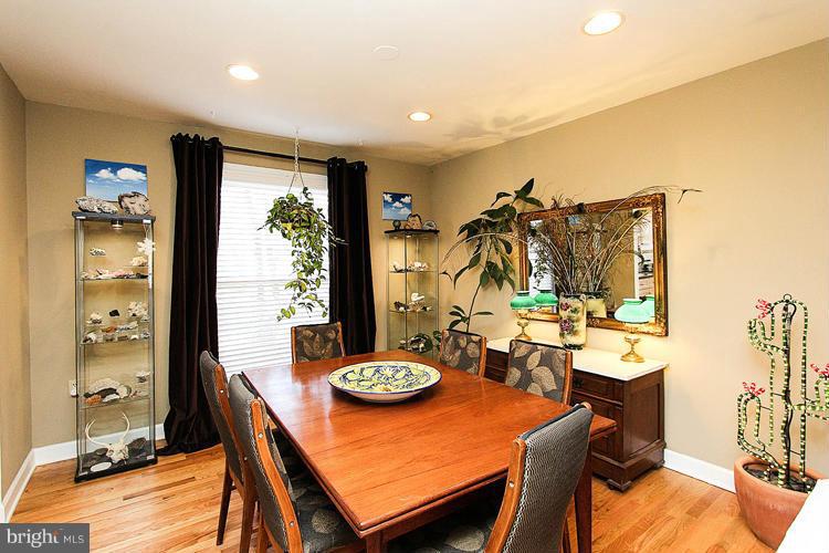 2104 Thomas View Road Reston, VA 20191 - Photo 7 of 29 a view of a dining room and livingroom with furniture wooden floor a chandelier