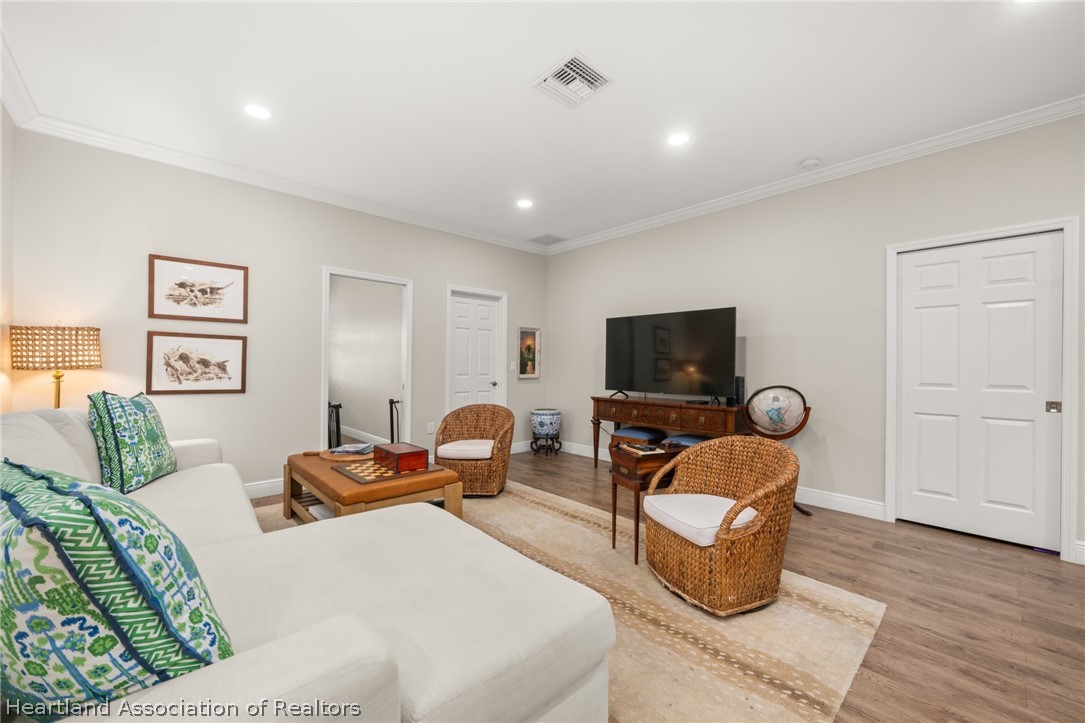 4734 Haw Branch Road, Unit 110 Sebring, FL 33875 - Photo 16 of 50 a bedroom with furniture and a flat screen tv