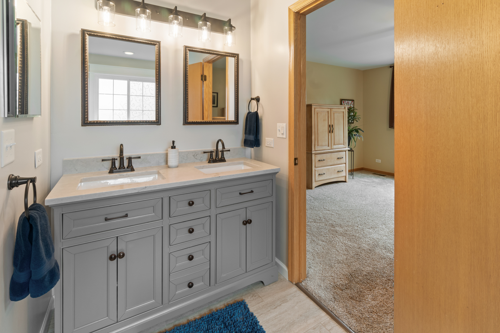 1985 Rochelle Court Wheeling, IL 60090 - Photo 13 of 38 a bathroom with a double vanity sink and mirror