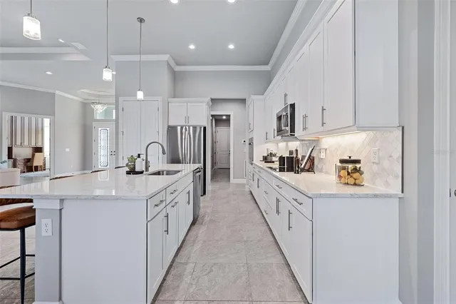 a spacious bedroom with a bed and a potted plant